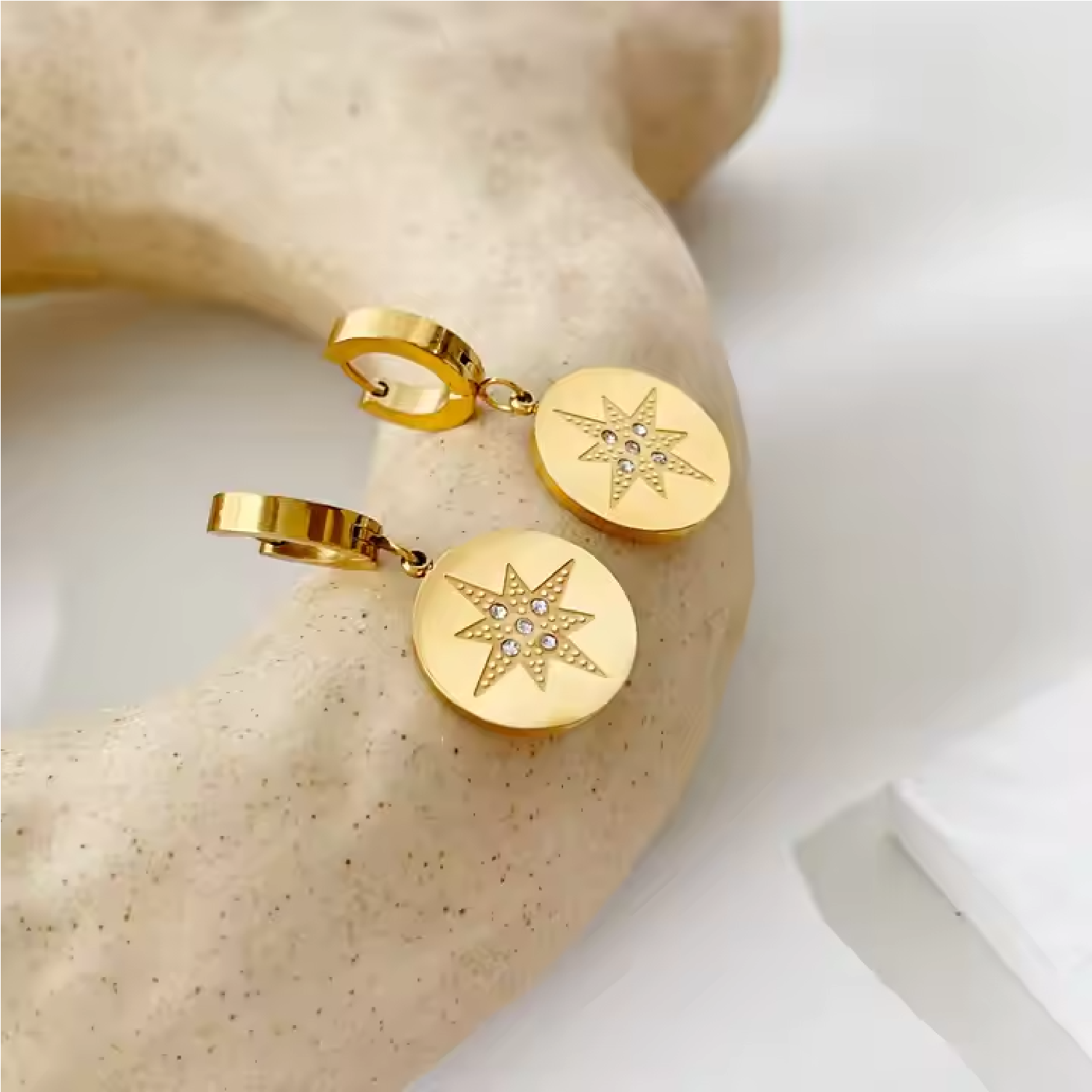 Eight Pointed Star Earrings on Marble